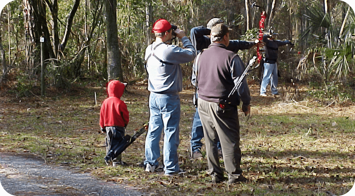 People shooting arrows outdoors