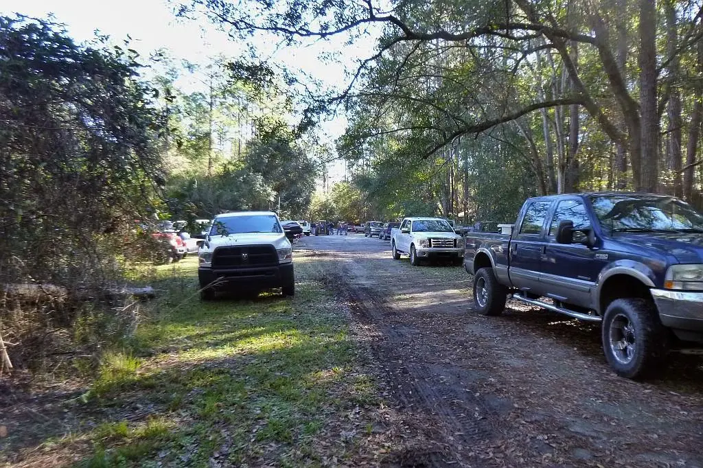 Vehicles lined up on a dirt path
