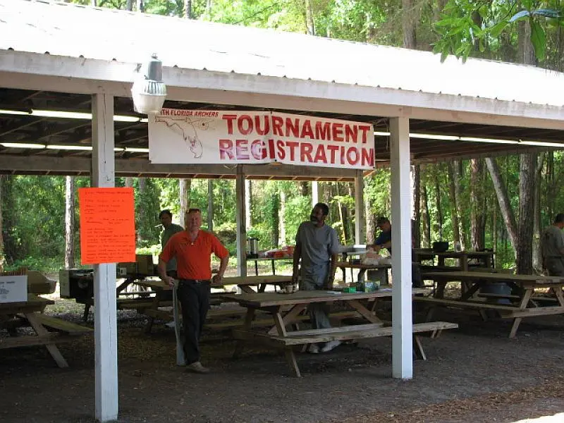 People gathering under event sign