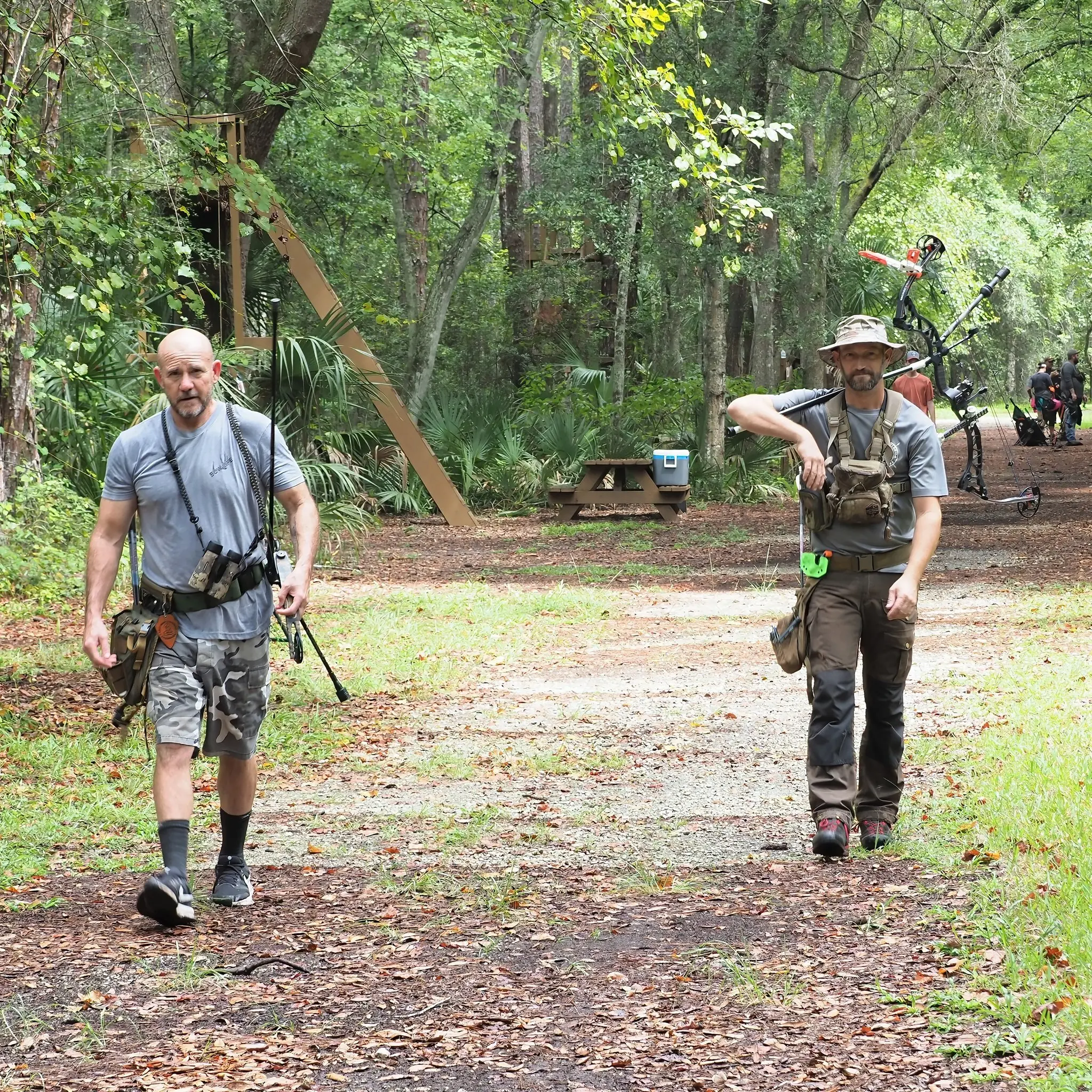 Archers strolling in forest path